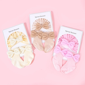 Three sets of ribbed cotton baby headbands with bows and matching non-slip socks