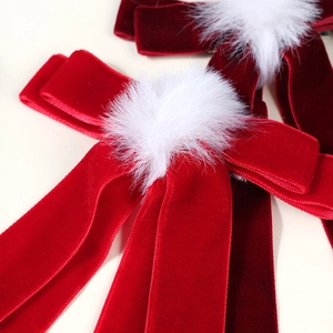 Red velvet bow hair clips with white faux fur pom poms in a pair for women styling