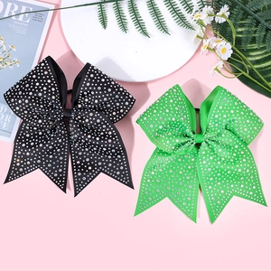 Detail of black and green rhinestone bows with ribbed texture for cheerleading styles