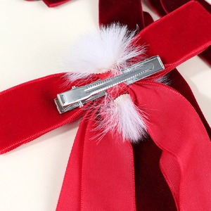 Red velvet bow hair clip with white pom poms and silver metal alligator clip back view