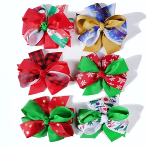 Set of six Christmas hair bows with festive patterns like reindeer and red plaid ribbons