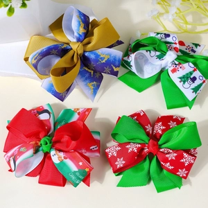 Close-up of assorted Christmas hair bows with festive reindeer and snowflake patterns