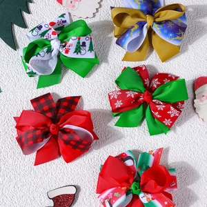 Flat lay of five Christmas hair clips with snowflakes, reindeer and tree patterns