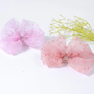 Detail of pink and purple polka dot mesh bows with sparkling rhinestone centers