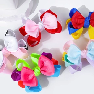 Close-up of five colorful double-layered grosgrain ribbon hair bows in various patterns