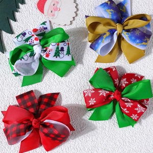 Detailed view of Christmas bow clips set featuring festive reindeer and snowflake patterns