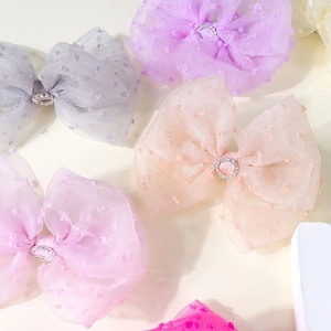 Polka dot mesh bow hair clips with rhinestone centers in various pastel colors