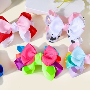 Close-up of colorful double-layered grosgrain ribbon bow clips on elegant stone props