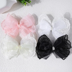 Set of four lace and gauze bow hair clips with pearls in pink, white, beige and black colors