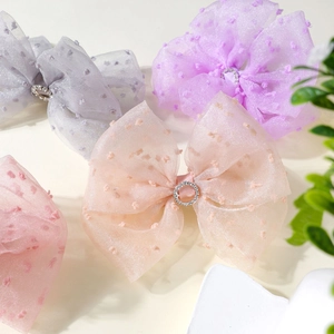 Bow hair clips with polka dot mesh and rhinestone center in multiple pastel colors