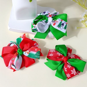 Detailed view of 3-piece Christmas hair bow set with festive reindeer and snowflake prints