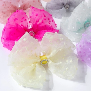 Close-up of colorful polka dot organza hair bows with sparkling rhinestone centers