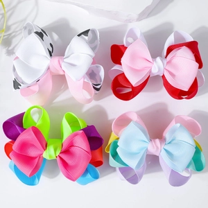 Set of four layered grosgrain ribbon bow hair clips in cow print and rainbow patterns
