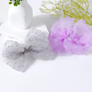 Polka dot tulle bow hair clips with rhinestone centers in light grey and lavender purple