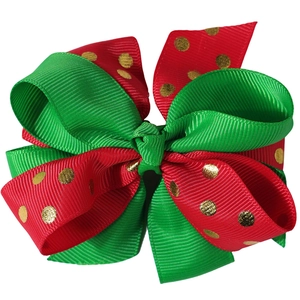 Detail of Christmas multi-layered hair bow with red and green grosgrain and gold dots