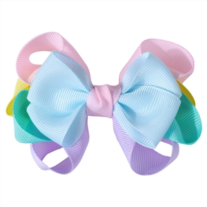 Close-up of layered grosgrain ribbon hair bow in colorful macabre pastel shades