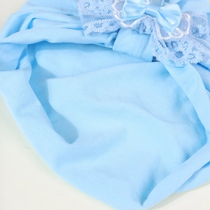 Close-up of light blue cotton baby turban hat with delicate lace bow and wavy edge details