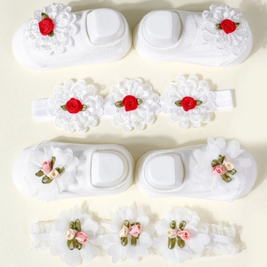 Detailed close-up of baby floral headband and knit socks set with delicate 3D roses