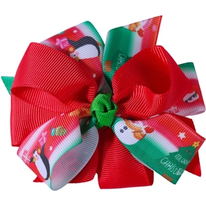 Detailed view of multilayer Christmas bow hair clip with festive penguin and snowman patterns