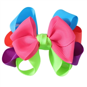 Detailed view of multilayered grosgrain ribbon bow hairpin with vibrant colorful stripes