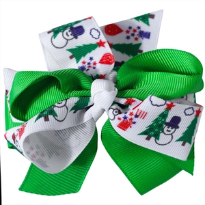 Detail of Christmas ribbon hair bow with snowman and tree patterns for kids