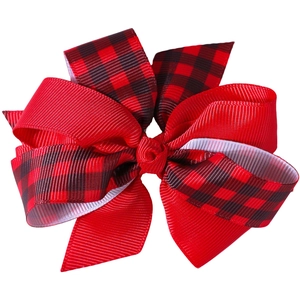 Detailed view of large Buffalo Plaid and red grosgrain ribbon layered Christmas hair bow