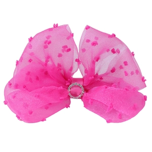 Detail of rose pink mesh hair bow with flocking polka dots and rhinestone center