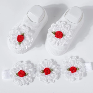 Detail of baby socks and headband set with white lace flowers and red rose accents