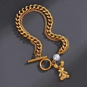 Double-layer gold chain bracelet with pearl and carved rabbit pendant and OT clasp closure