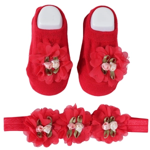 Detail of red baby socks and headband set with decorative 3D mesh floral lace applique