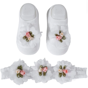 Detail view of baby socks and headband set with white mesh flowers and small satin roses