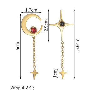Detail view of asymmetric tassel earrings with moon and star design with measurements