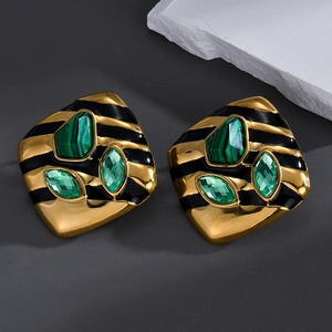 Vintage gold shield earrings with malachite stones and green crystals on grey background