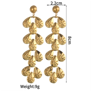 Detail showing 8cm long gold tassel earrings dimensions and engraved flower pattern