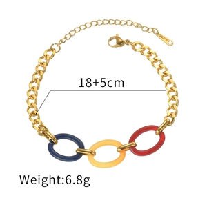 Detail view of gold chain bracelet with blue, yellow, and red resin charms and steel tag