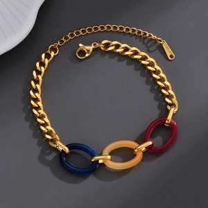 Chunky gold stainless steel link bracelet with colorful resin accents in blue and amber