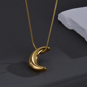 Polished 18K gold crescent moon pendant on a sleek snake chain necklace for women