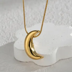 Minimalist 18K gold plated crescent moon pendant necklace with sleek snake chain on white base