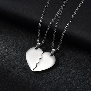 Polished stainless steel couple necklace featuring interlocking split heart pendant on black leather