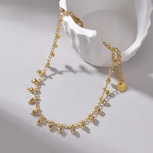 Detail of 14K gold plated titanium steel bracelet with faceted beads on ceramic decor