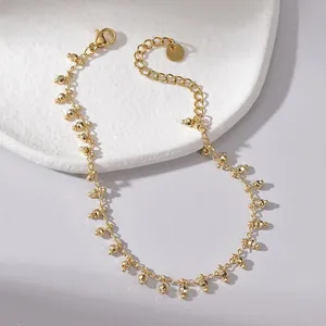 Detail of 14K gold plated titanium steel bracelet with faceted beads and lobster clasp