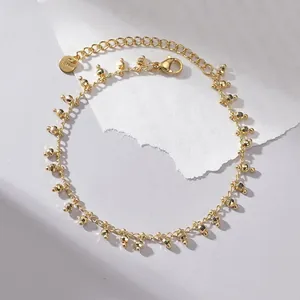 Detailed close-up of 14K gold plated stainless steel bracelet with faceted gold beads
