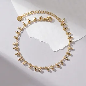 Minimalist 14K gold plated stainless steel bracelet with faceted beads and tassel details