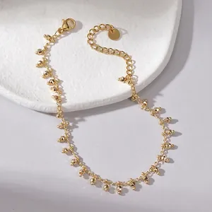 Elegant 14K gold-plated titanium steel bracelet featuring geometric textured beads and clasp