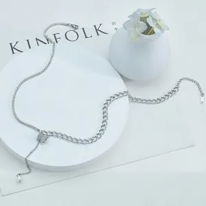 Minimalist butterfly tassel necklace with silver chain and pearl pendant on white stand
