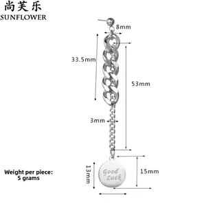 Detail view of silver chain drop earring with Good Luck engraved round pendant