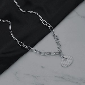 Collier en acier inoxydable avec pendentif cœur ajouré sur une chaîne à maillons mixtes