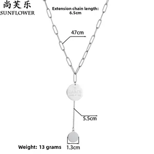 Detail of silver stainless steel chain with round pendant and tassel drop charm
