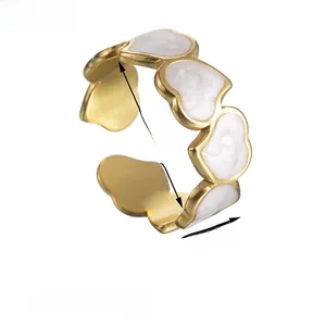 Detail view of 17mm adjustable golden heart ring with white enamel and 8mm width