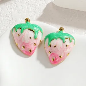 Elegant strawberry enamel earrings in gold-tone metal with marble texture and green leaf detail